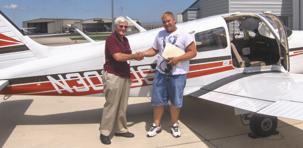 Picture of Brad Bulanda being congratulated by his instructor, Keith Williams.