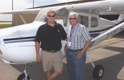 Picture of student and instructor standing beside Cessna 172 airplane.